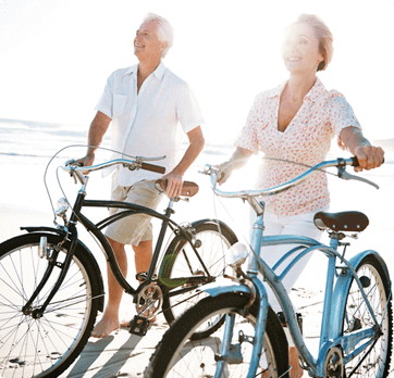 man and woman riding bicycle at the beach 